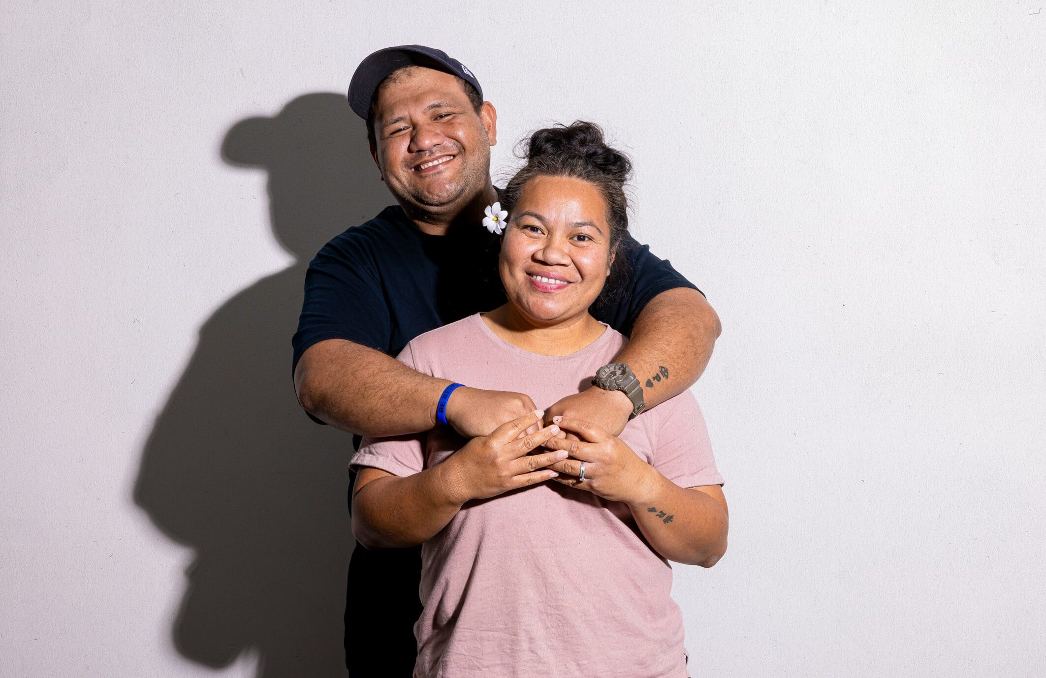 A man and woman smiling and hugging