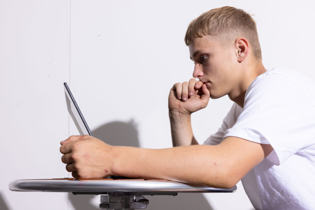Teenager looking at laptop